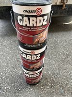 Stacked two full 1-gallon cans and one half-gallon can of Zinsser Gardz primer showing label