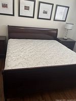 Overall view of assembled sleigh bed frame with mattress in guest room