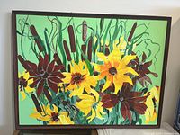 Frontal view of the framed painting showing sunflowers, cattails, and green foliage on a vibrant green background.