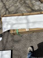Roll of white magnetic and writable wall covering laid out over a box, showing texture and condition