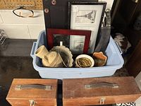 Frames, wooden boxes, dagger in case, copper and clay pots grouped in bin and on surface.