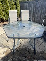 Octagon glass tabletop with green-toned metal frame and legs