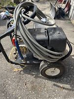 Side view of unit with coiled hose, frame, and wheels