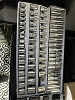 Tray with polished chrome sockets organized by size and measurement