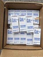 Top view of the open box showing multiple boxes of heavy duty number 12 single edge industrial razor blades packed inside.