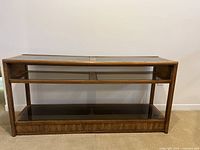 Front view of the vintage wooden sofa table showing wooden frame and smoky glass shelves.