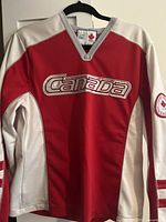 Front view of red and white hockey-style Canada jersey with Canada logo on chest