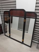 Full view of the vintage folding 3-piece mirror with carved frames and brass hinges