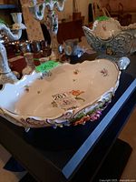 Interior view showing painted flower motifs and scalloped gold rim