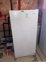 Front exterior view of white upright freezer