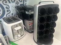 Photo showing Keurig coffee maker, Toastmaster 2-slice toaster, and Keurig reusable pod rack on countertop.