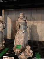 Front view of seated woman with cherub at feet