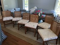 Six chairs arranged in living space.