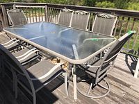 Overall view of table and chairs on deck from one side