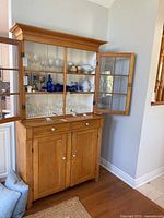 Full front view of pine hutch with contents inside