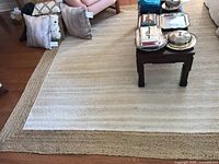 Full view of rectangular jute rug under furniture