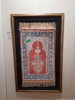 Framed silk prayer rug full view hung on wall