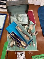 Brown leather and green velvet lined spoon presentation case stamped 'Ryland Ross Toronto' with slots for spoons