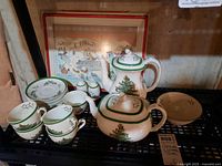 Full set on shelf including coffee pot, teapot, cups, saucers, salt & pepper, bowl and placemats