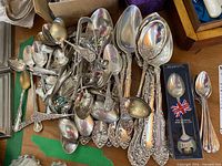 Pile of assorted sterling silver spoons with various patterns