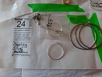 Multiple items displayed including hoop earrings, three bracelets and two necklaces with pendants