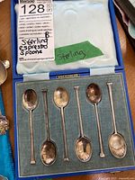Six vintage sterling silver espresso spoons arranged in original case lined with light blue fabric.