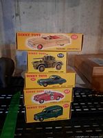 Five boxed Dinky Toy models stacked