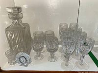 Full view of all items: Waterford crystal decanter, ten stemmed glasses, toothpick holder, and crystal clock.