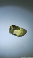 Clear photo of a natural lemon citrine cushion cut gemstone with yellow color and good clarity