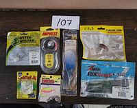 Overall view of 6 fishing baits in packaging on wooden surface