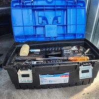 Open Mastercraft tool box showing assorted tools inside including white mallet, screwdrivers, sockets, metal hand tools
