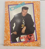 Front view of poster showing Donnie Wahlberg photo with orange and white border and text