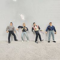 Front view of all four New Kids on the Block figurines standing side by side.