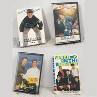 Four vintage New Kids on the Block bubble gum cases displayed together showing front artwork of band members.