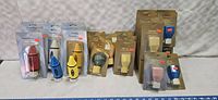 Wide shot of the assortment of new old stock night lights in original packaging, showing multiple styles and colors.