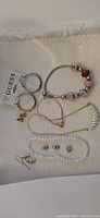 All jewelry visible in the lot showing earrings, bracelets and necklace.