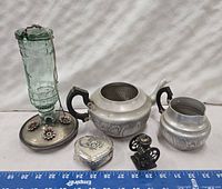 Full lot overview with hummingbird feeder, trinket box, teapot and creamer, pencil sharpener