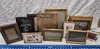A collection of 12 assorted picture frames displayed upright with visible styles and sizes.