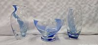 Set of three Lenox glass pieces, two vases and one bowl, clear with blue accents and dolphin engravings