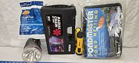 Photo showing four items: Radial Chain tire chain case, Pondmaster pond netting in sealed bag, large aluminum flashlight, and yellow multi-tool or pump with gauge.