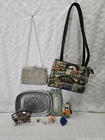Front view of the vintage silver-tone beaded clutch purse with chain, Venice-themed fabric shoulder purse, pewter dish, thermometer, figurines, rings and clip on a white background