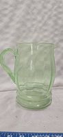 Photo of vintage green uranium glass pitcher showing front