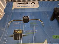 Blue box for Weslo Cardiostride 4.0 treadmill showing product features including workout stats display and integrated device shelf.