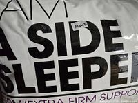 Close-up photo of pillow packaging showing brand and product line text 'I AM A SIDE SLEEPER FIRM EXTRA FIRM SUPPORT'.
