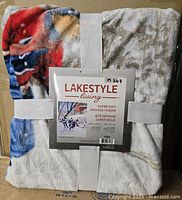 Folded Lakestyle Living super soft printed throw blanket with label showing product details