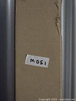 Cardboard packaging of curtain rod set with label 'M051'