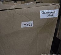 Box exterior showing label 'COURTYARD21 2-Pack' and handwritten lot number 'M066'