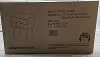 Cardboard box with printed item details: 20" Olivia Two-Drawer Side Table in Dark Walnut, quantity 1, item number AF20OLI2DDW