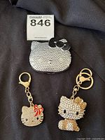 Large Hello Kitty rhinestone mirror compact with two rhinestone Hello Kitty keychains
