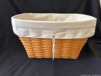American Craft Laundry Basket (2000) with white cotton drawstring liner visible inside the woven basket.
